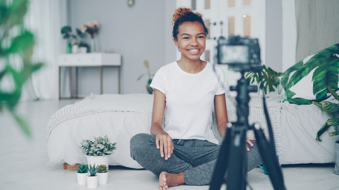 Content creator setting up a phone on a tripod to film a video